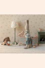 Maileg - Cot Bed Micro - Powder - Strawberries & Cream - Ingrid Lewis - Designer 
Children's room with plush toys, a lamp, and a crib against a floral wallpaper.