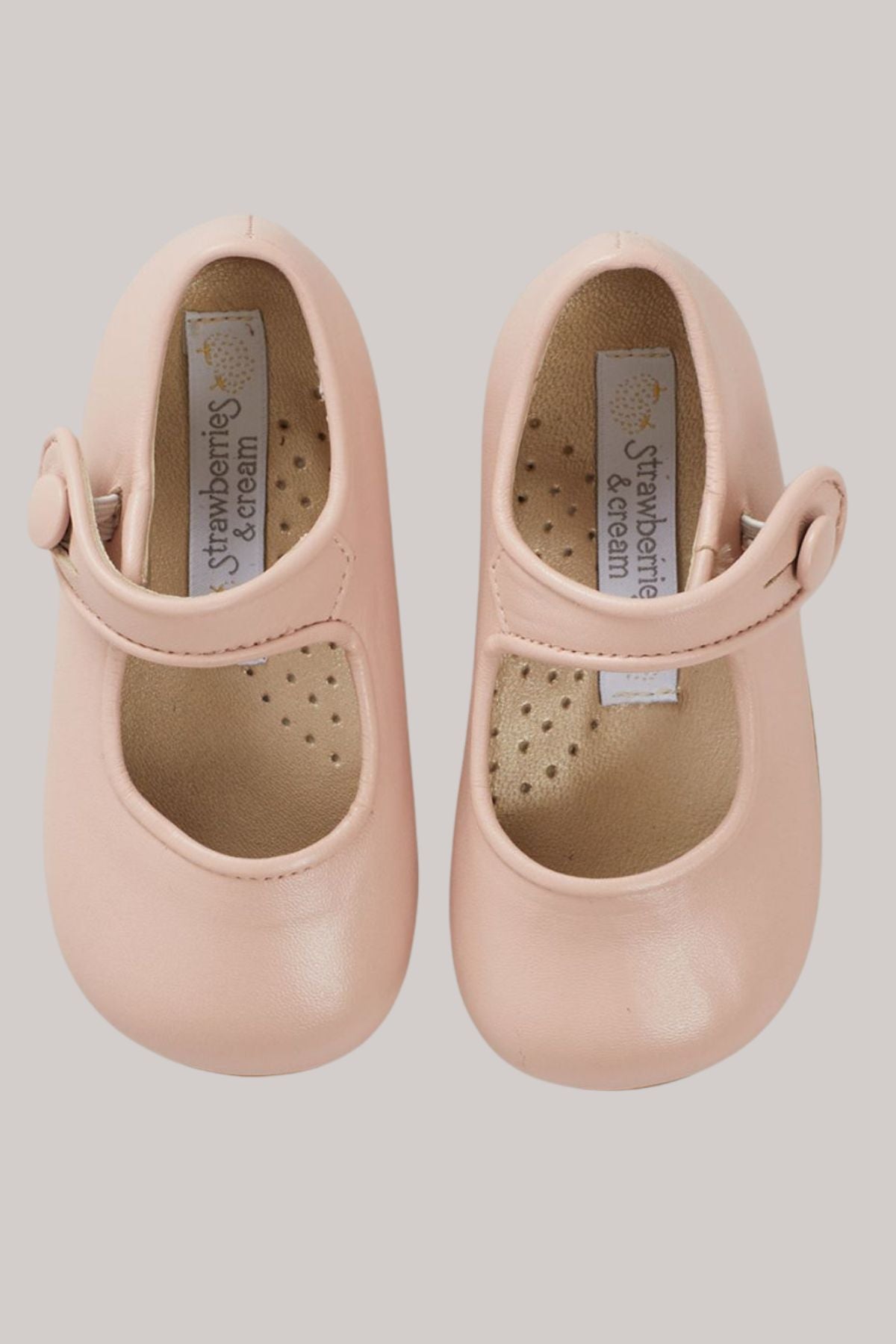 xBaby Mary Jane - Pink - Strawberries & Cream - Ingrid Lewis - Designer
Pair of pink shoes with 'Strawberries & Cream' label on a grey background