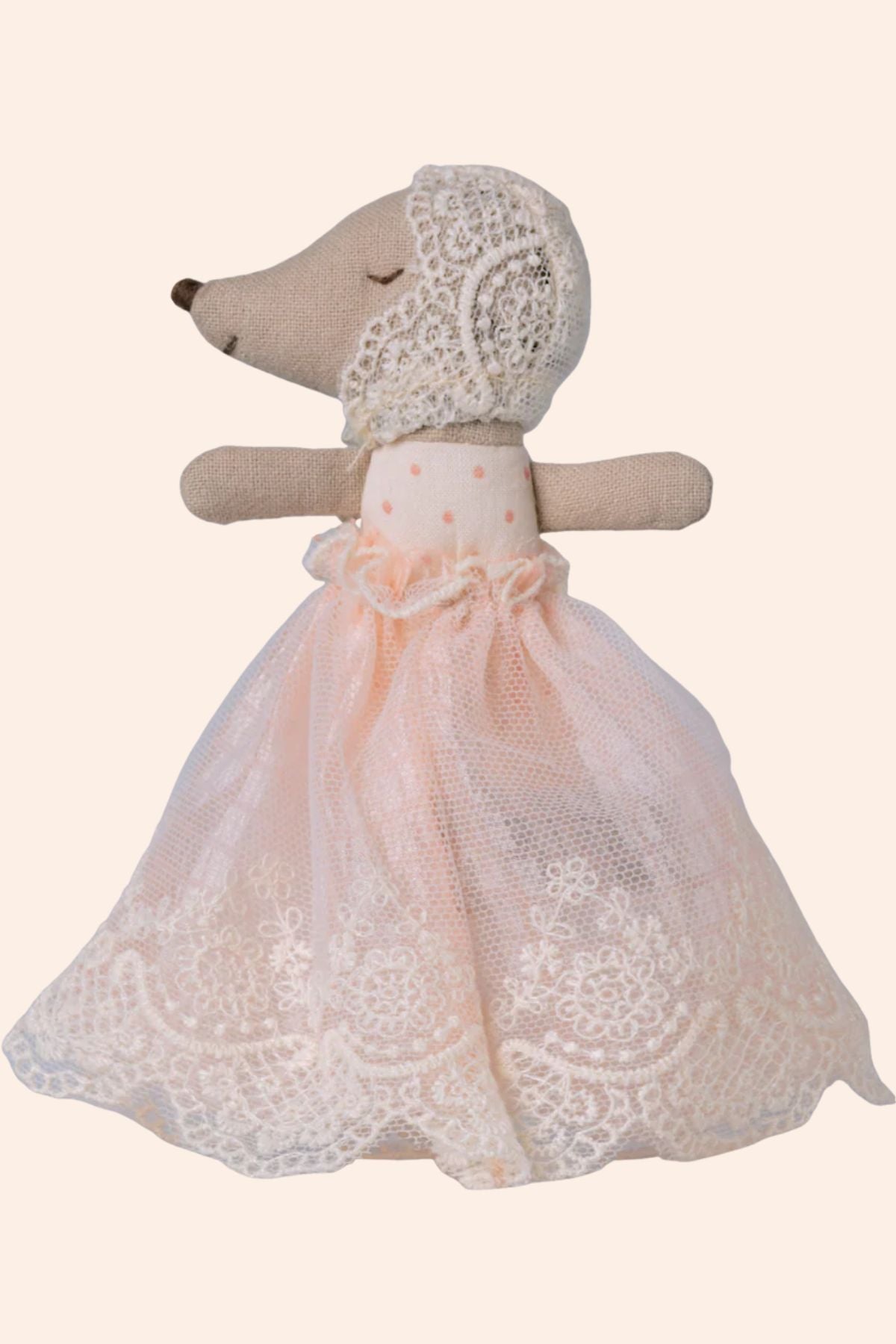 Stuffed animal toy with a lace dress on a white background