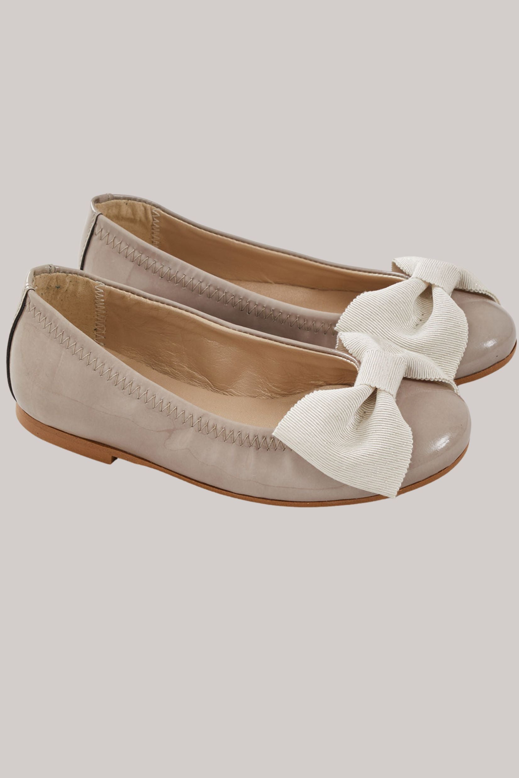 Ballerina Bow - Patent Leather Taupe - Strawberries & Cream - Ingrid Lewis - Designer 
 Pair of beige flats with white bow detail.