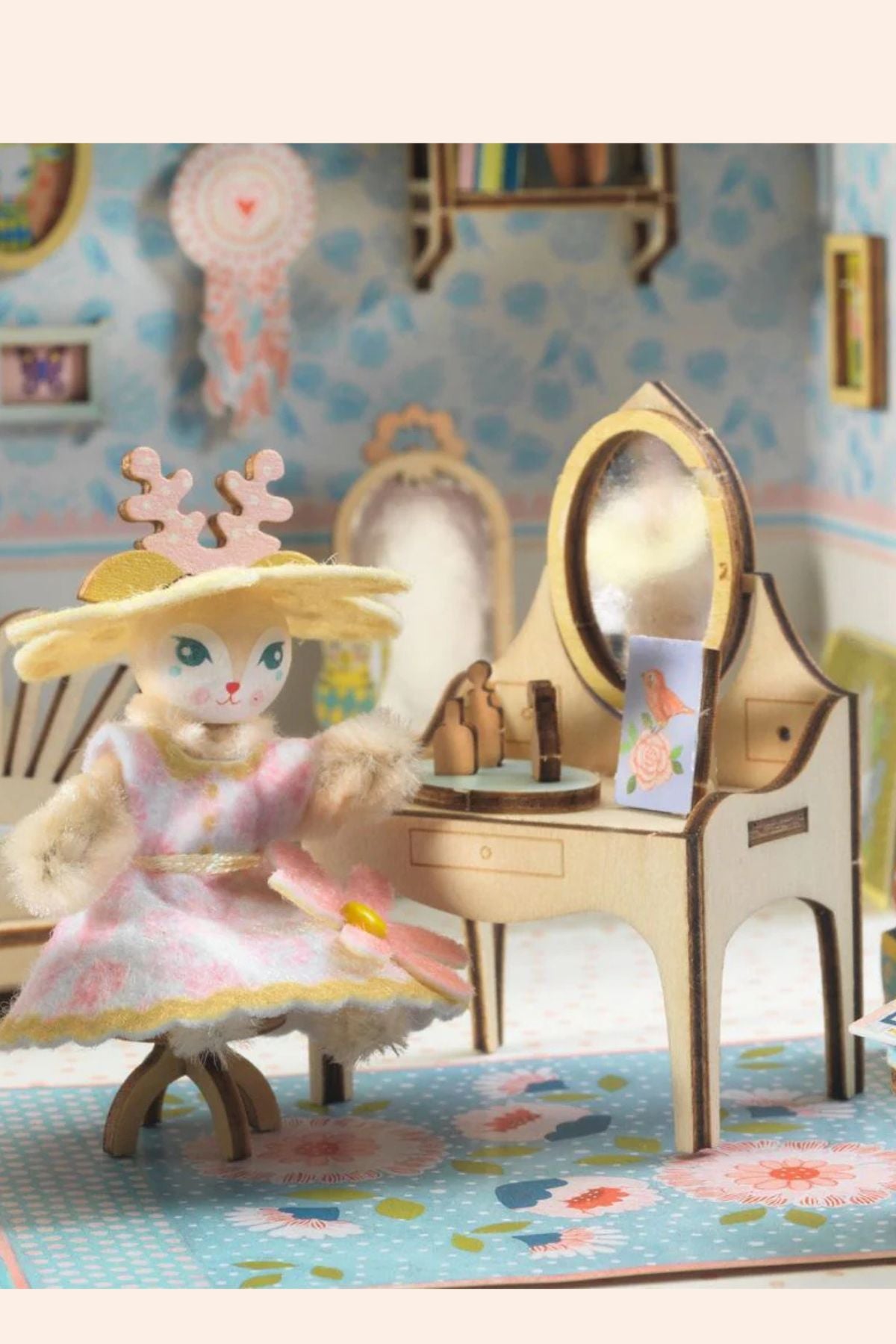 Djeco - Mi House - Alba - Strawberries & Cream 
Toy cat in a dress sitting next to a vanity table with a mirror in a dollhouse setting.