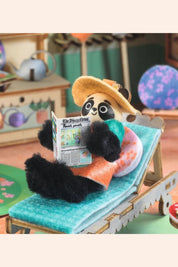 Djeco - Mi House - Olive - Strawberries & Cream 
Panda toy reading a newspaper on a deck chair.