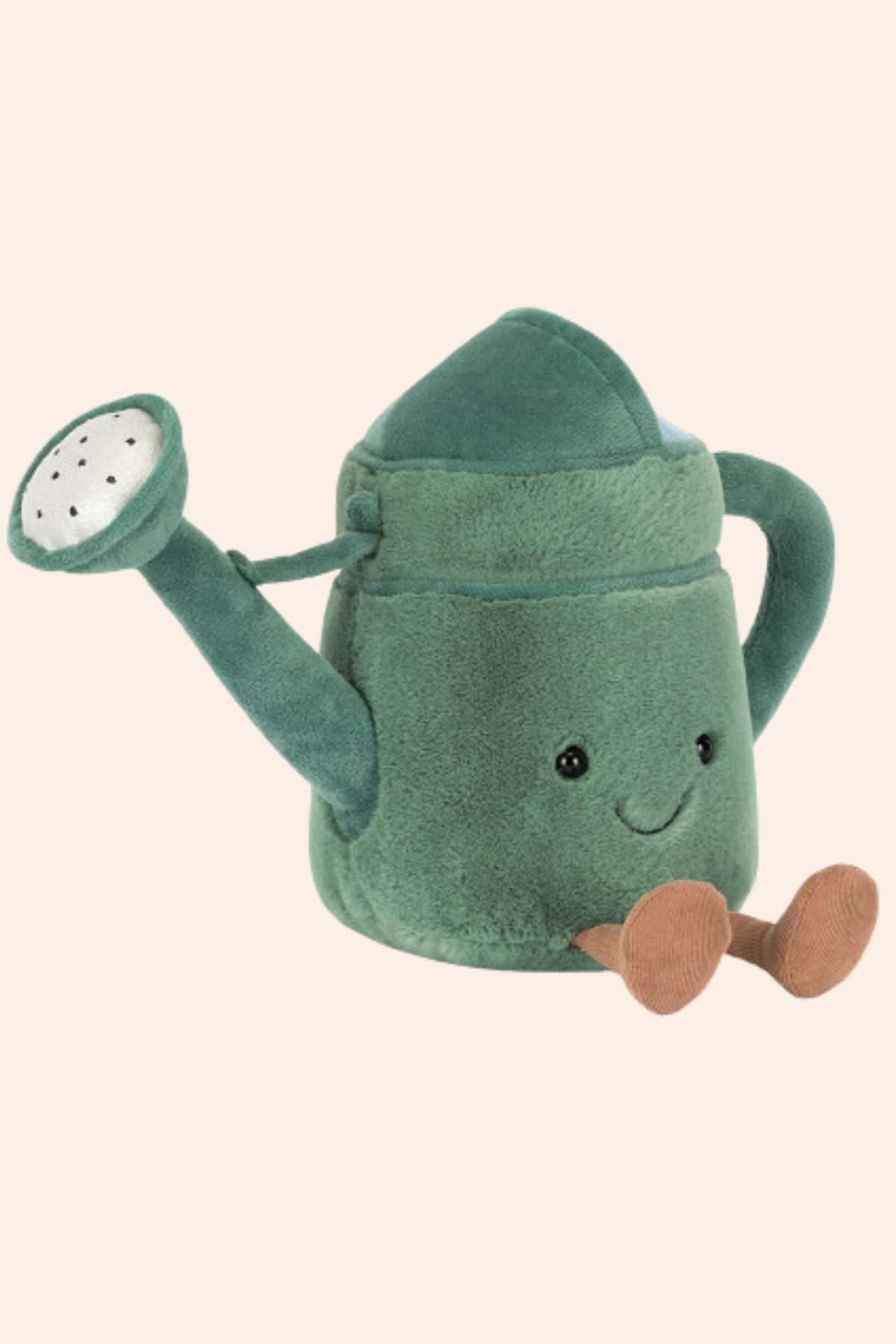 Plush toy watering can with a smiling face on a beige background