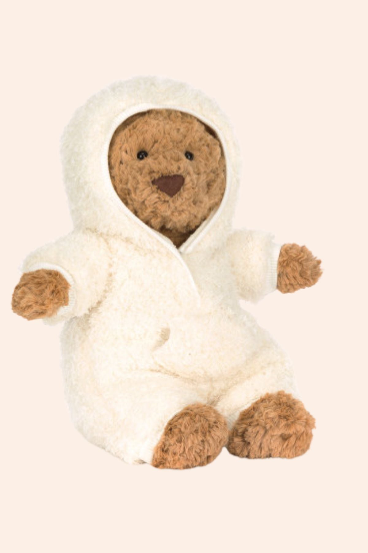 Teddy bear in a white outfit on a beige background