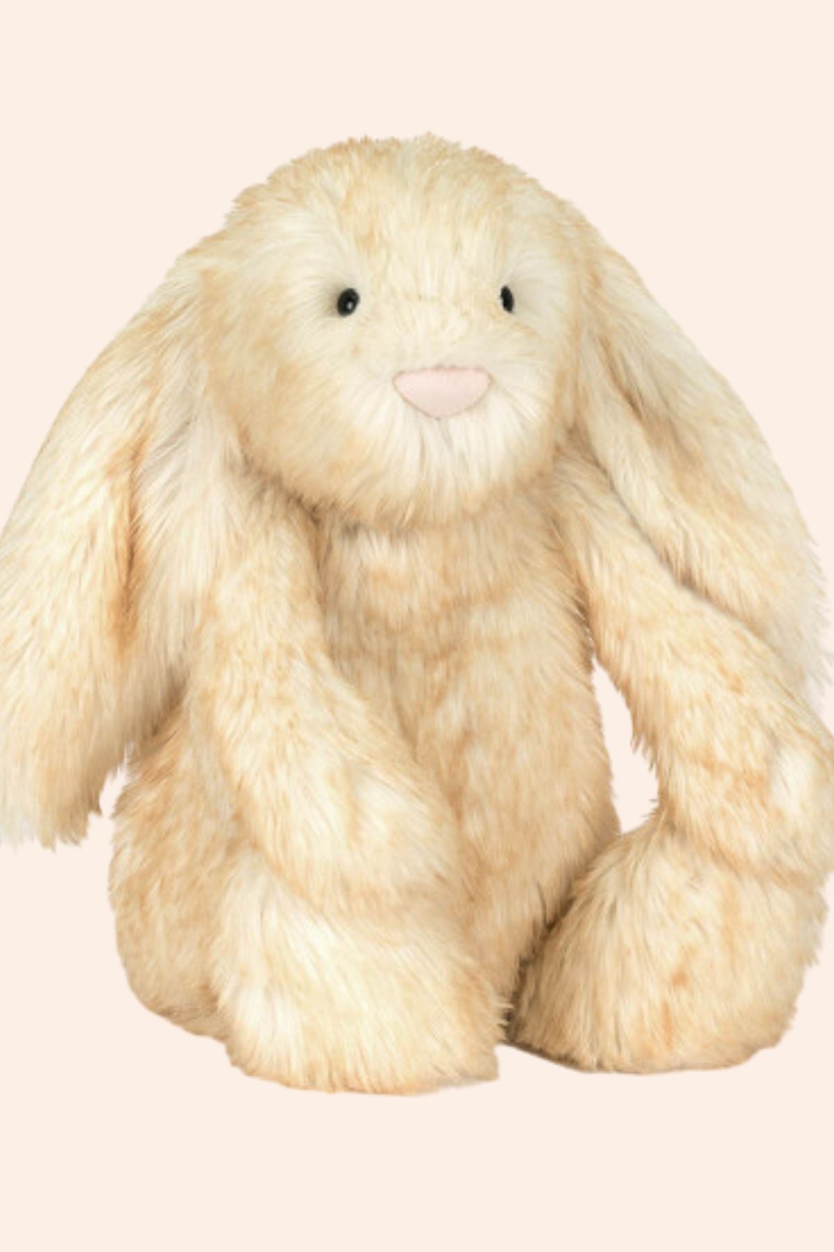 Plush toy rabbit with long ears on a beige background