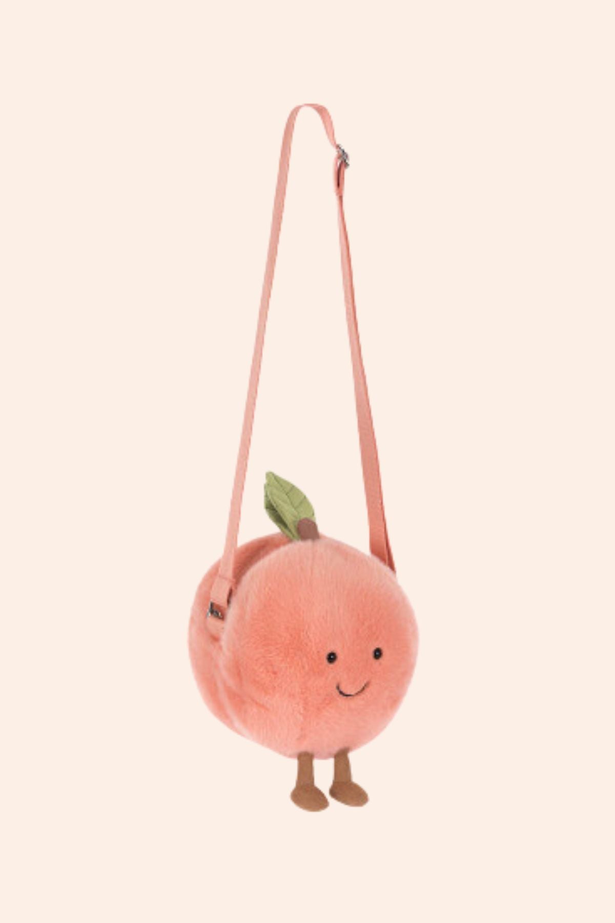 Plush peach-shaped bag with a strap on a light pink background