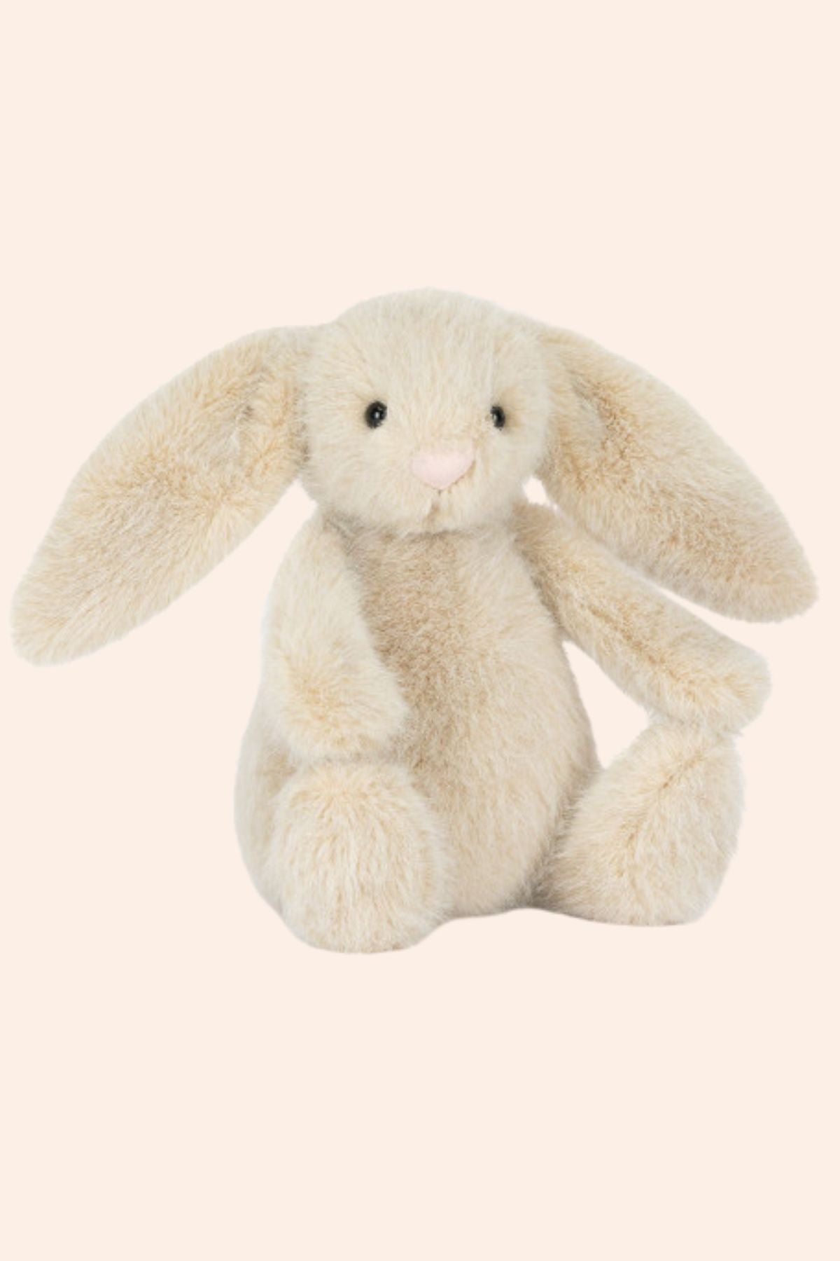 Plush bunny toy on a beige background