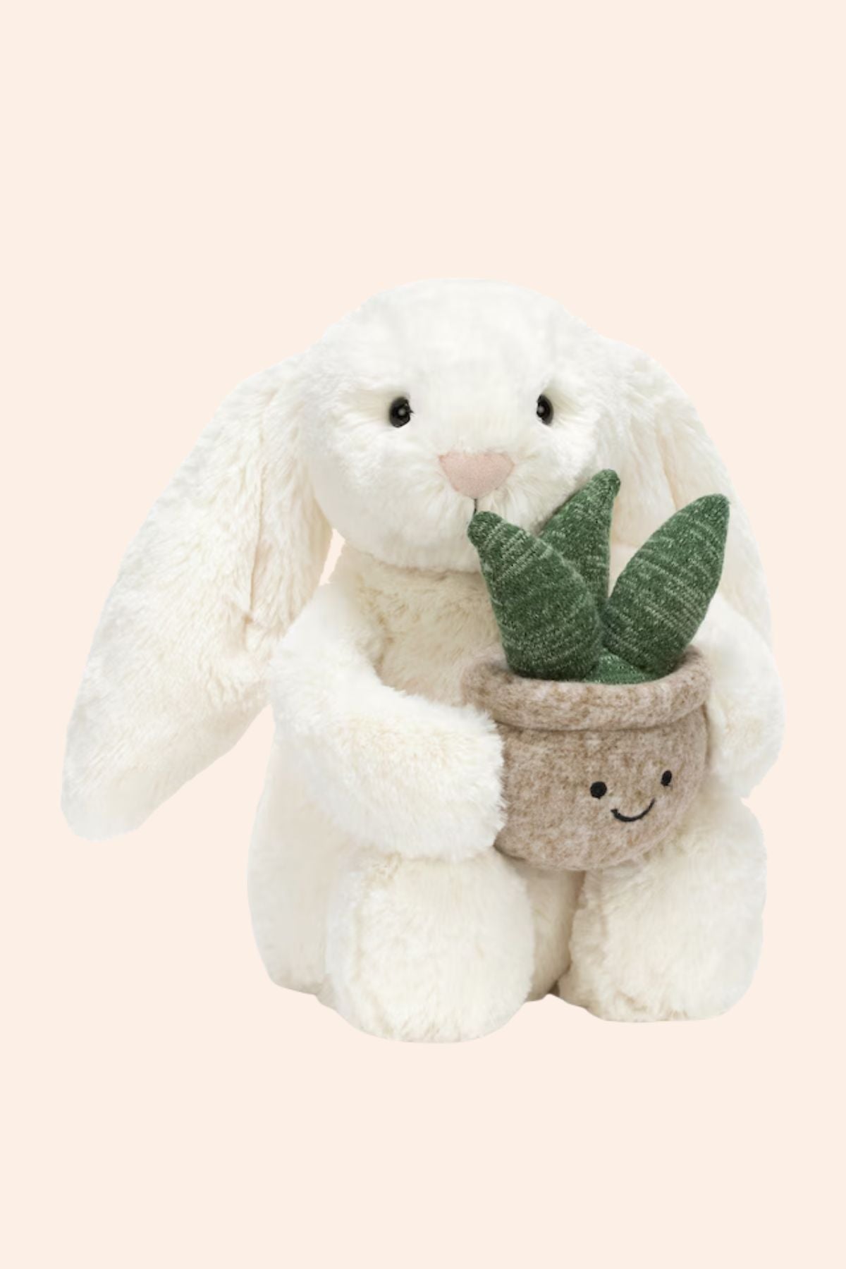 Jellycat - Cream Bunny with Plant - Strawberries & Cream - Ingrid Lewis - Designer 
Jellycat Plush bunny holding a potted plant with a smiley face