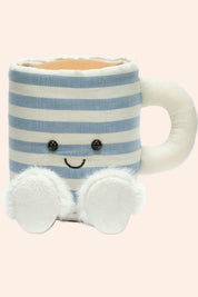 Striped mug with a smiling face and white paws on a light pink background