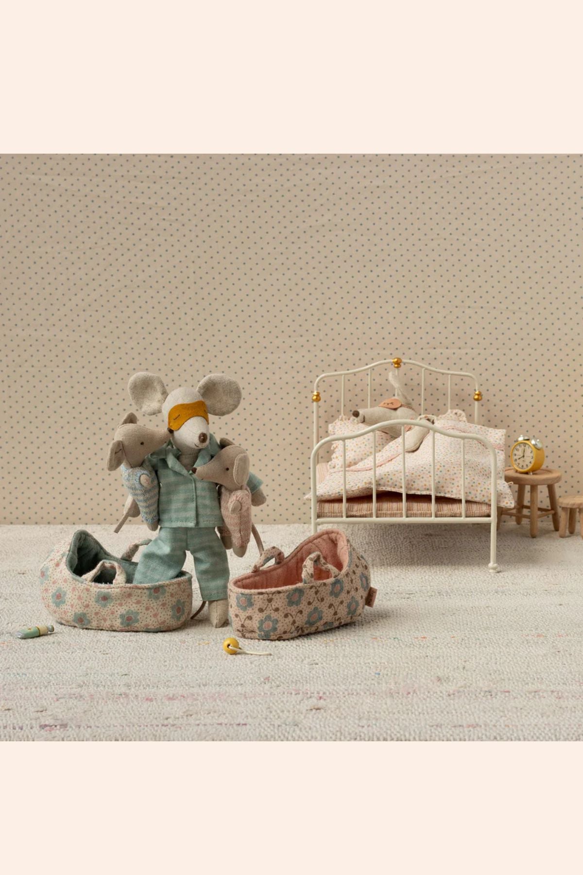 Maileg - Baby Mouse in Carry Cot - Blue - Strawberries & Cream - Ingrid Lewis - Designer
Miniature scene with toy mice and a small bed in a room with patterned wallpaper.