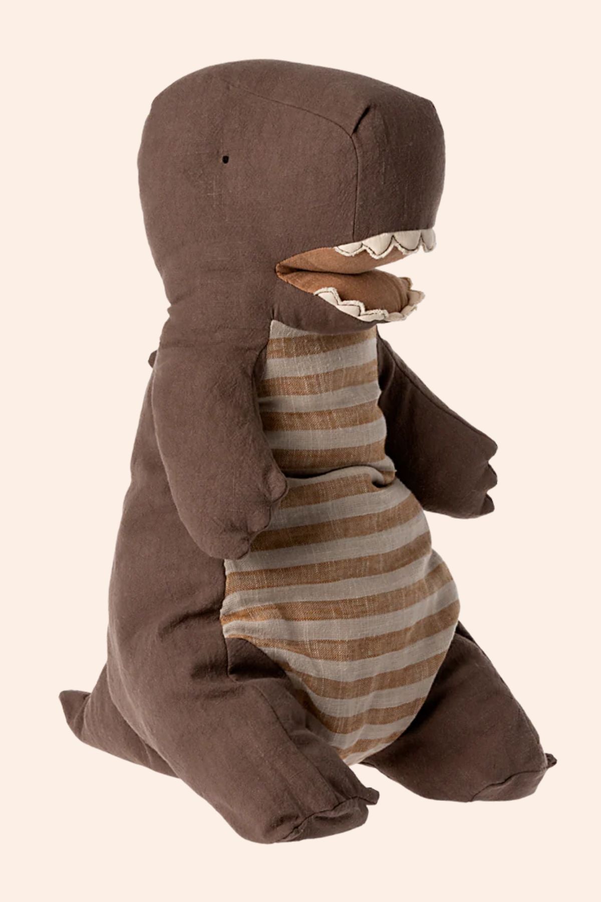 Children's plush toy in a brown shark costume with striped shirt on a beige background