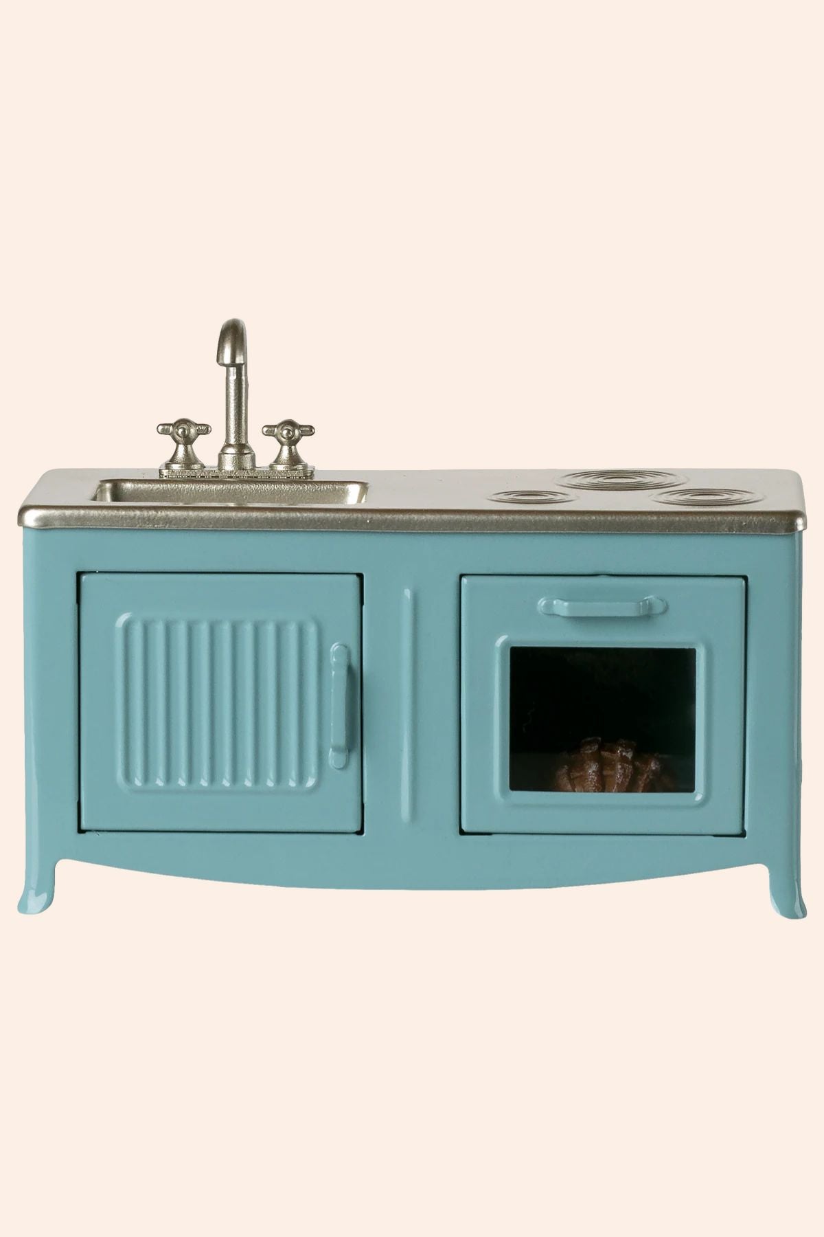 Blue kitchen sink unit with metallic fixtures on a beige background