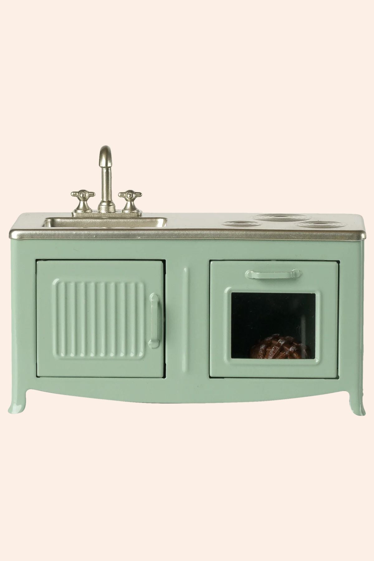 Mint green kitchen sink unit with a small window on a white background