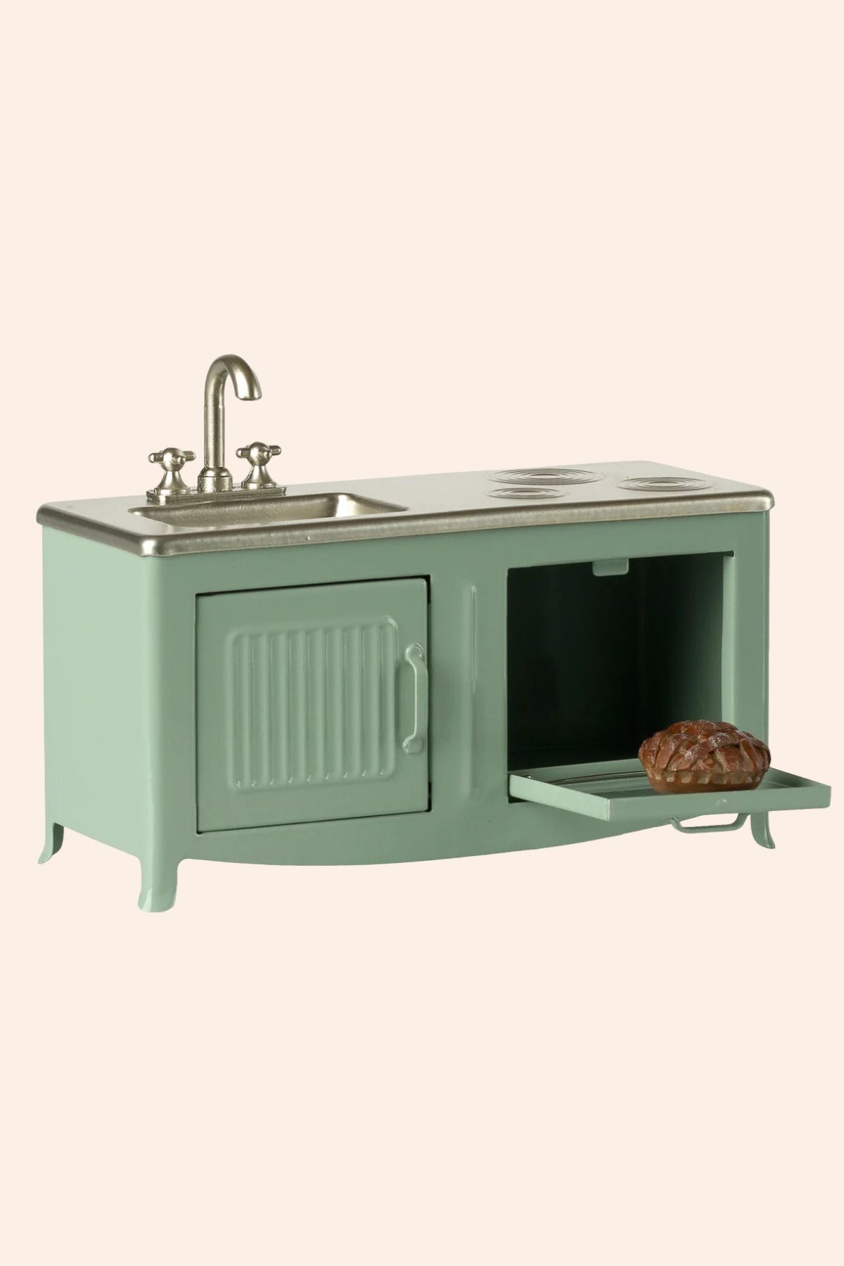 Green metal cabinet with sink and open door on a beige background