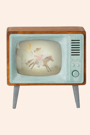 Vintage television set with a fairy on a horse on the screen against a white background