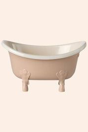 Small bathtub with a white interior on a beige background