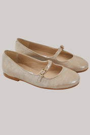 Mary Jane - Patent Leather Beige - Strawberries & Cream - Ingrid Lewis - Designer
Pair of beige shoes with a strap.