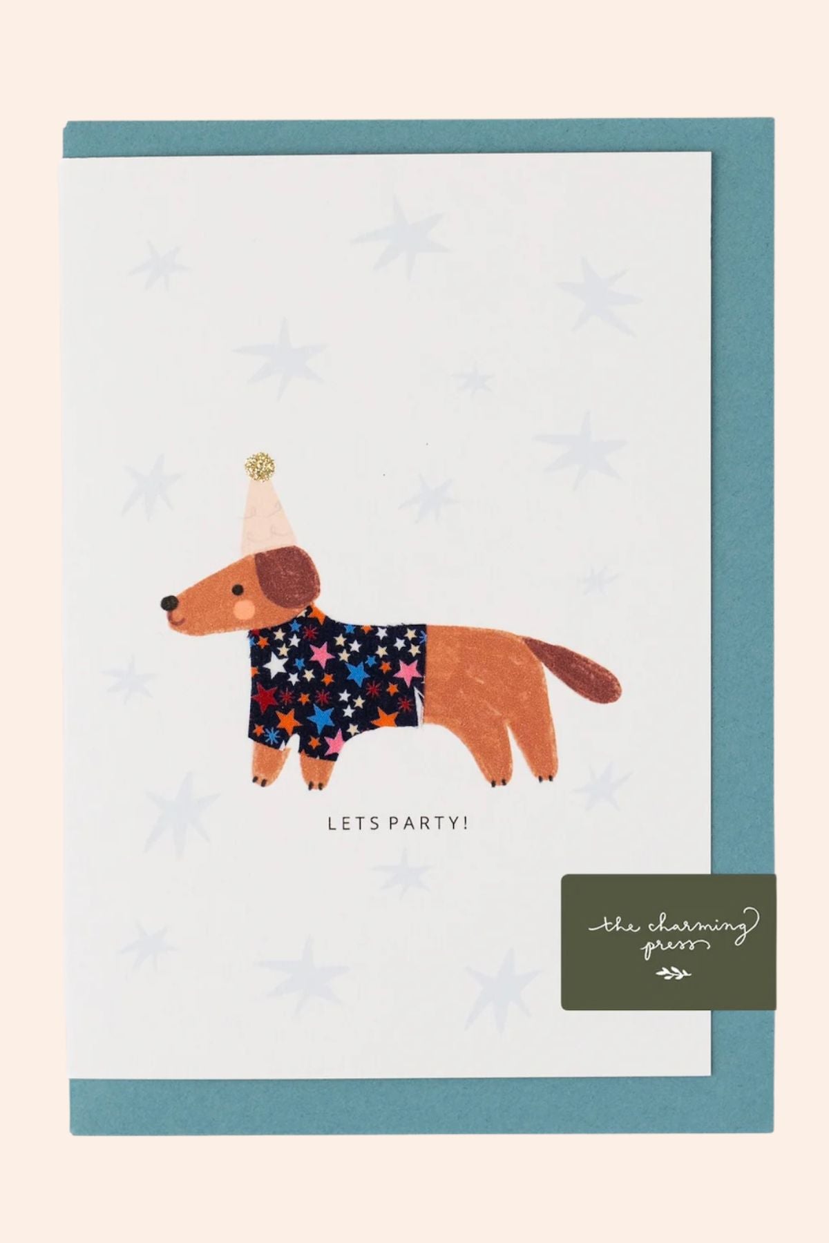 Card with a dachshund wearing a party hat and star-patterned shirt on a light blue background.