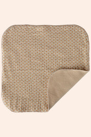 Textured square mat with a patterned top and solid bottom on a white background